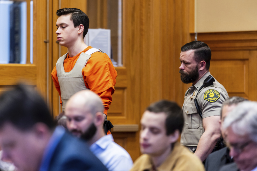 FILE - Willard Miller is led into a courtroom, March 29, 2023, in Fairfield, Iowa, for a hearing related to the murder charge he faces in the 2021 death of Fairfield, Iowa, Spanish teacher Nohema Graber. Miller, one of two Iowa teenagers charged in the beating death of an Iowa high school teacher, pleaded guilty on Tuesday, April 18, 2023, to first-degree murder.