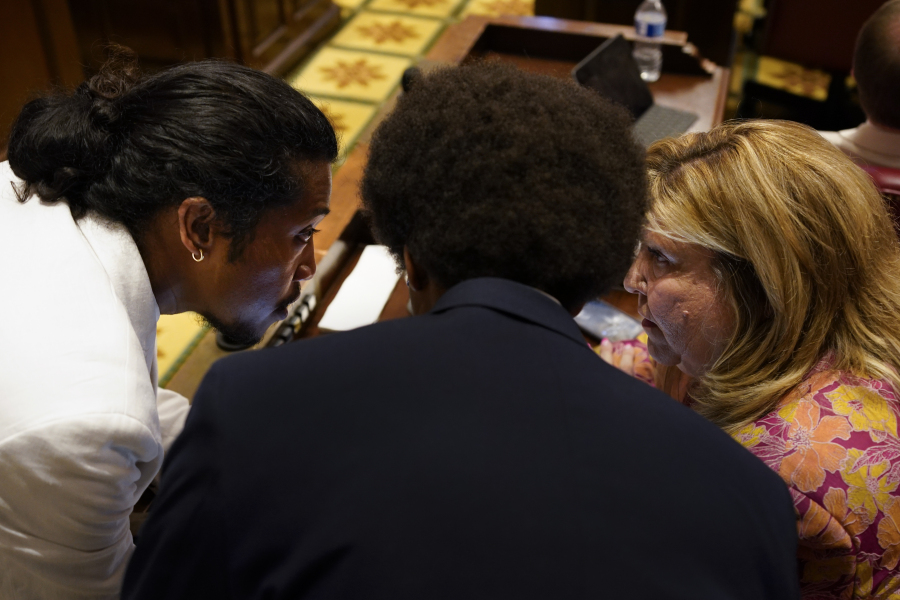 Former Rep. Justin Jones, D-Nashville, former Rep. Justin Pearson, D-Memphis, and Rep. Gloria Johnson, D-Knoxville, confer on the floor of the House chamber before expulsion proceedings for the three Democrats begin Thursday, April 6, 2023, in Nashville, Tenn. Jones and Pearson were expelled from the legislature for using a bullhorn to shout support for pro-gun control protesters in the House chamber.