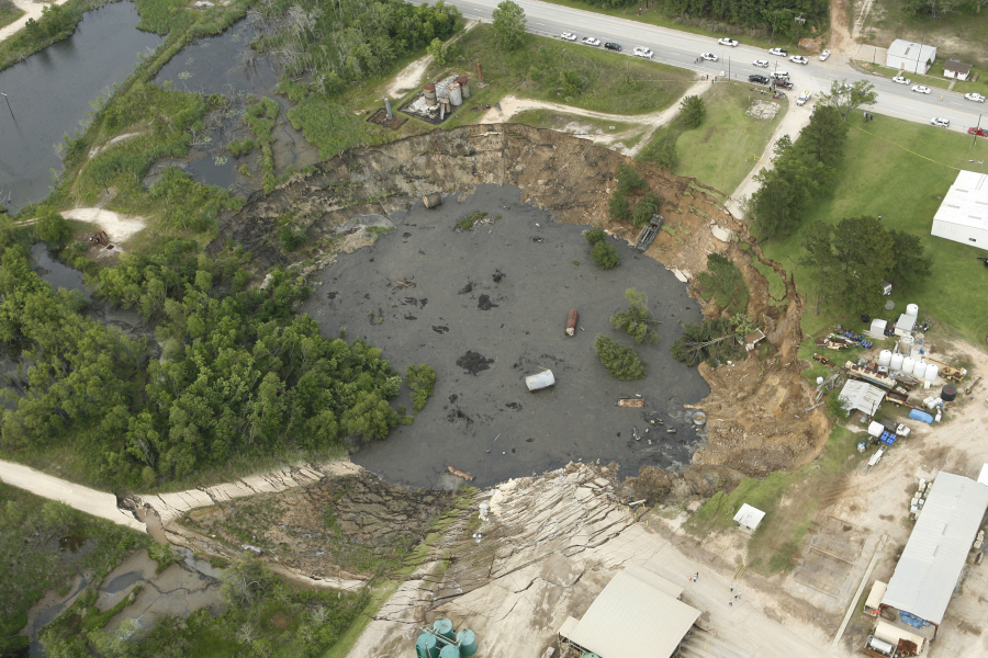 FILE- This aerial image shows a massive sinkhole near Daisetta, Texas, Wednesday afternoon, May 7, 2008. Earlier this month, Daisetta officials announced the sinkhole, which had first emerged in 2008 but had been dormant since then, had started to again expand. Officials say they're monitoring the new growth and keeping residents informed.