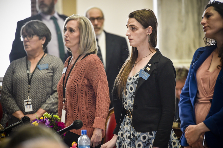 Rep. Zoey Zephyr, D-Missoula, second from right, stands with members of the minority party on the house floor on Thursday, April 20, 2023 at the state capitol in Helena, Mont.
