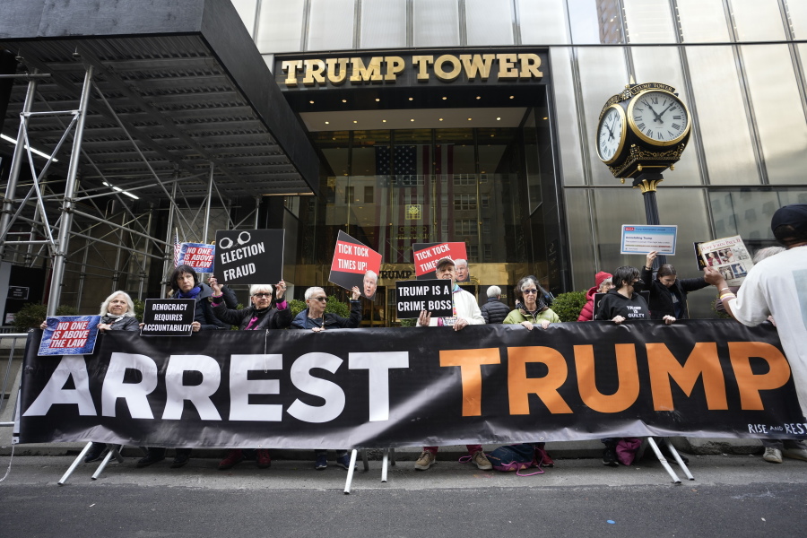 FILE - Protesters gather outside Trump Tower on Friday, March 31, 2023, in New York. Former President Donald Trump was indicted by a Manhattan grand jury the day before, an historic reckoning after years of investigations into his personal, political and business dealings and an abrupt jolt to his bid to retake the White House.