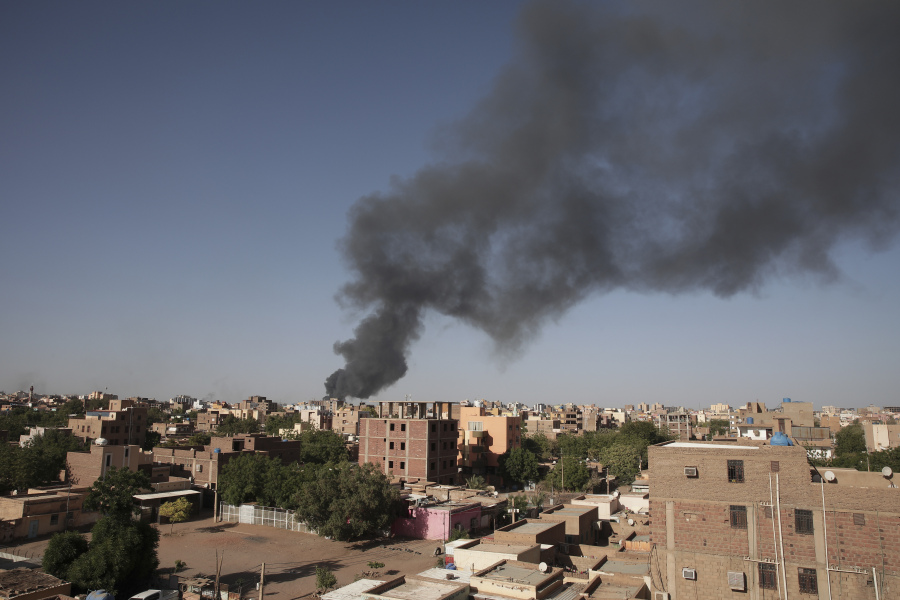 FILE - Smoke is seen in Khartoum, Sudan, Wednesday, April 19, 2023. The U.S. conducted its first organized evacuation of citizens and permanent residents from Sudan, the State Department said Saturday, April 29, two weeks into a conflict that has turned Khartoum into a war zone and thrown the country into turmoil. American unmanned aircraft, which have been keeping an eye on overland evacuation routes for days, were providing armed overwatch for the American operation, according to two people briefed on the operation who were not authorized to speak publicly.