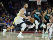 Golden State Warriors guard Stephen Curry drives to the basket against the Portland Trail Blazers during the second half of an NBA basketball game in Portland, Ore., Sunday, April 9, 2023.