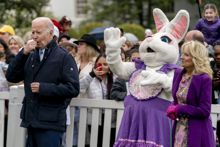 FILE - President Joe Biden, accompanied by first lady Jill Biden blows his whistle for the start of a race during the White House Easter Egg Roll, April 18, 2022, in Washington.