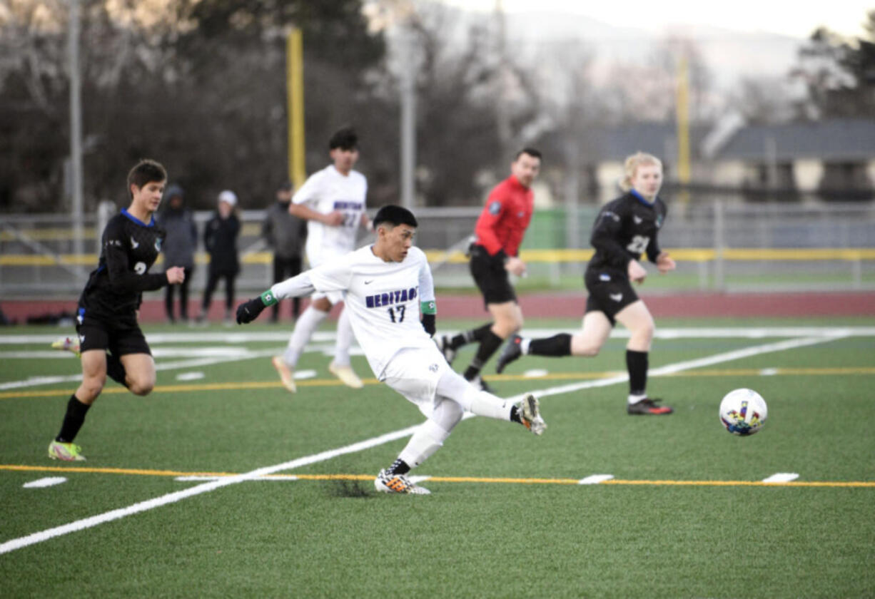 Heritage's Mijail Cusitito Cueva (17) sends a pass forward against Mountain View on April 11. The Timberwolves earned their first 3A GSHL title in program history Monday.