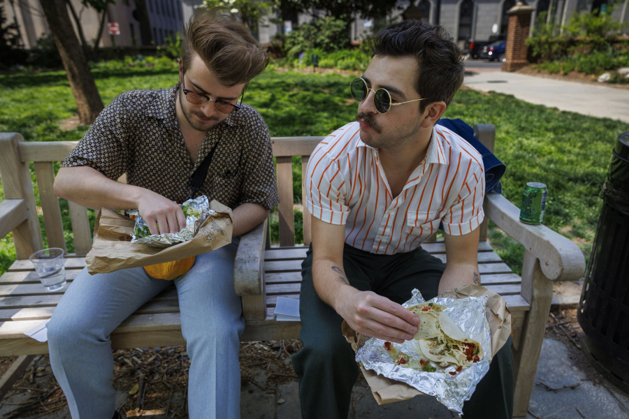 Architects Thomas Keller and Henri Brooks (right) eat tacos from El Fuego in Washington Square Park. "I eat Mexican twice a week," Keller said. (Alejandro A.