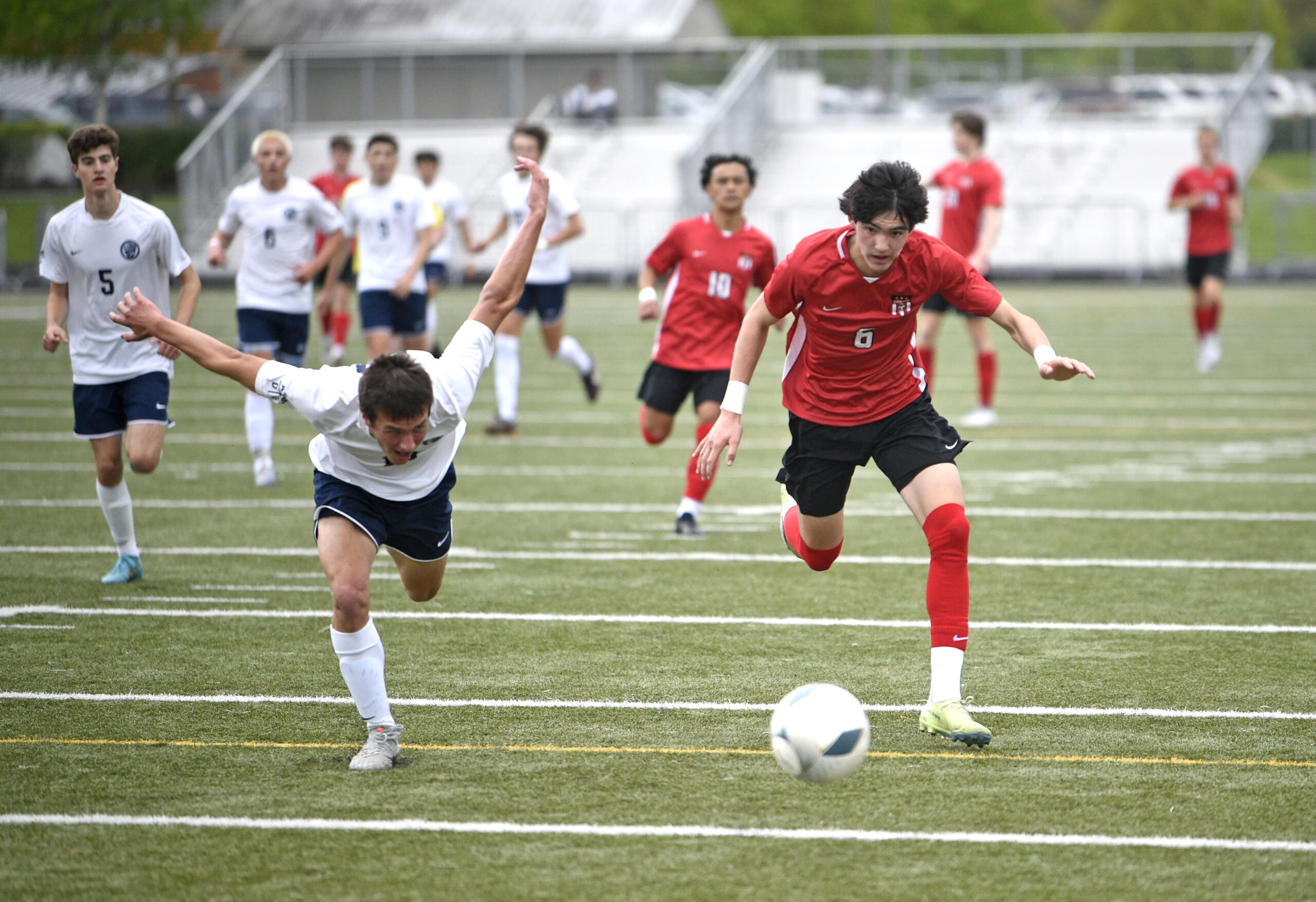 Camas freshman Luke Manandic, right, and Bellarmine Prep’s Jack Merriam scramble for a loose ball during a Class 4A bi-district boys soccer game on Saturday, May 6, 2023, at Doc Harris Stadium.