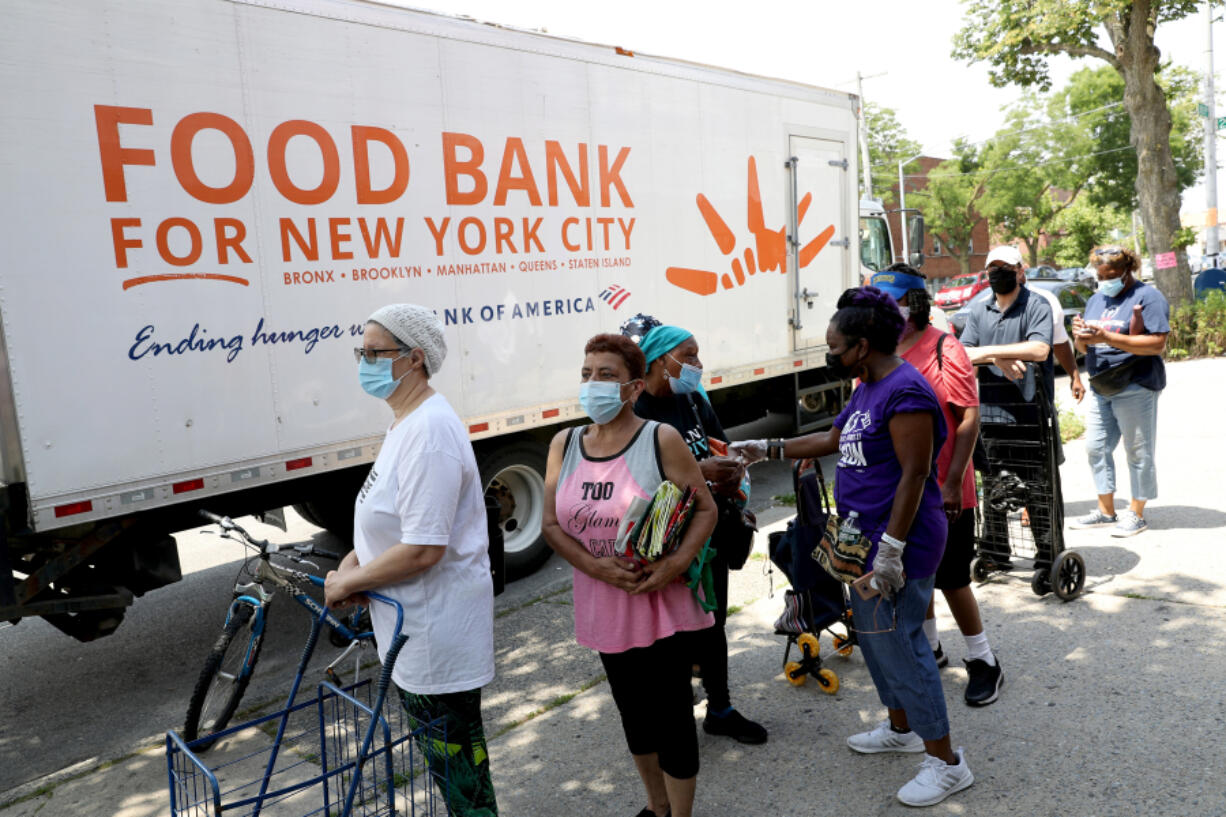 IOn this photo from June 19, 2021, Queens community members line up to receive food from Food Bank for New York City  at Deliverance Baptist Church in Cambria Heights, New York.