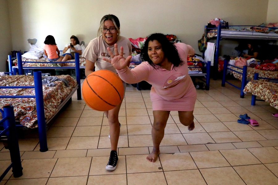Jennifer Angel Constancio, 15, left, of Michoacan, Mexico, and Duria Romero, 32, of Honduras, play a game of keep away at Albergue Del Desierto on Wednesday, May 10, 2023 in Mexicali, Baja California. Title 42, a pandemic-era policy that allowed border agents to quickly turn back migrants, expires this week. Under a new rule, the U.S. on Thursday will begin denying asylum to migrants who show up at the U.S.-Mexico border without first applying online or seeking protection in a country they passed through.