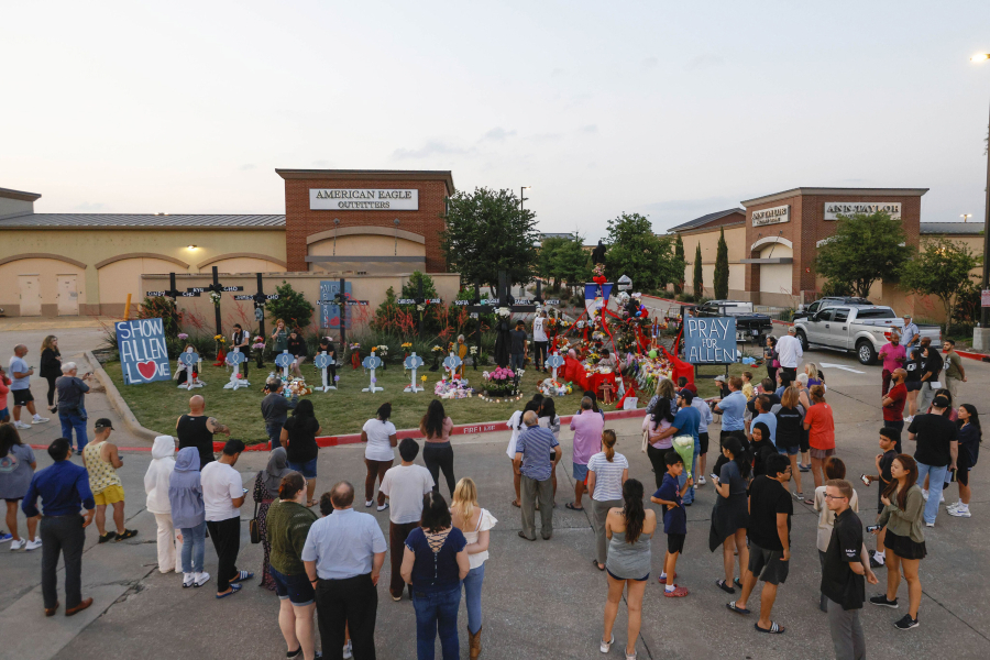 People gather at the memorial outside the mall honoring the victims of a mass shooting at Allen Premium Outlets in Allen, Texas on Monday, May 8, 2023. A gunman fatally shot eight people and wounded seven others Saturday at the mall before being killed by a police officer.