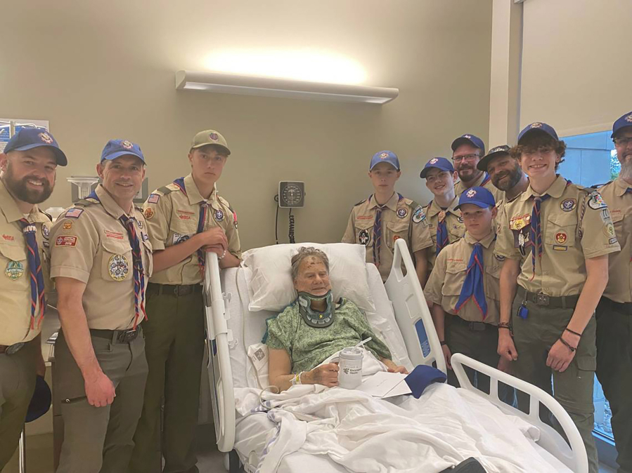 Eric Valentine poses with members of Troop 77 from his hospital bed on May 15. Members of the troop were on a canoe trip May 6 when they were flagged down and able to help Valentine after he fell in Hells Canyon.