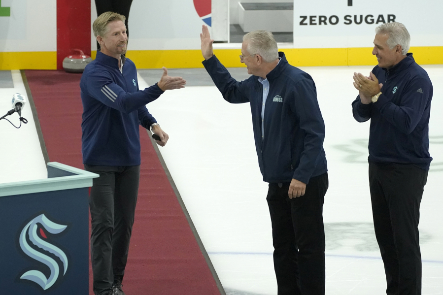 Seattle Kraken head coach Dave Hakstol, left, with team CEO Tod Leiweke, center, and general manager Ron Francis. Seattle?s management is still dealing with the mixed emotions that came with the Kraken?s unexpected playoff run and the disappointment when it ended. (AP Photo/Ted S.