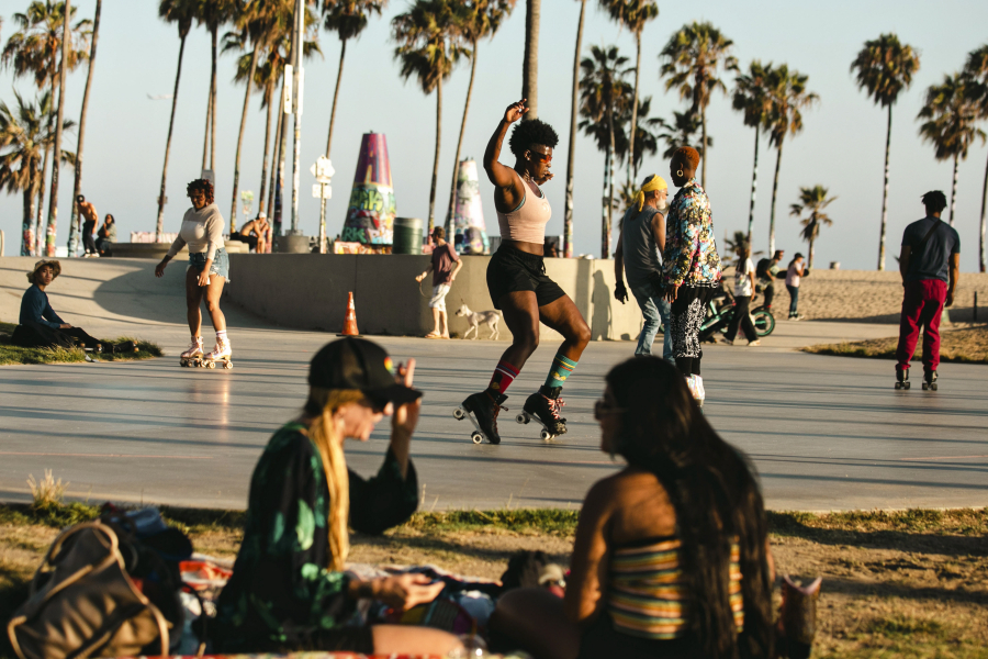 Bianca Povalitis, center, along with fellow roller skaters enjoy an evening at Venice Beach Skate Plaza in June 2022.