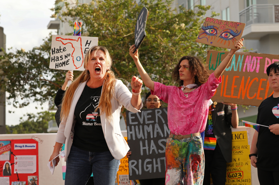 J. Marie Bailey, a former teacher with the Orange County public schools, speaks up for freedom of speech and against book banning and repression of LGBTQ students, April 11, 2023. At right is Will Larkins, a senior at Winter Park High School in Florida.