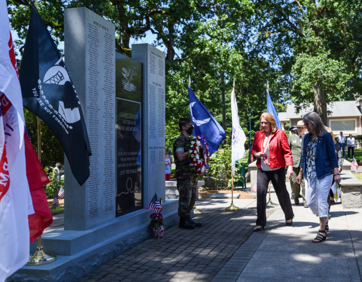 Vancouver Mayor Anne McEnerny-Ogle, right, and Gold Star mother Meredith McMackin, far right, walk toward the Clark County Veterans War Memorial in 2021, during a wreath laying ceremony as part of a Memorial Day observance at the Fort Vancouver Artillery Barracks.