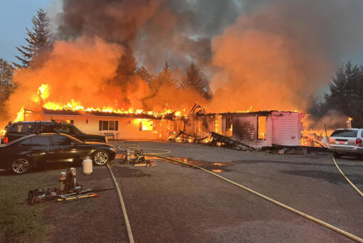 An adult family living center burns Tuesday morning north of Camas. Ten residents were displaced and the building was destroyed.