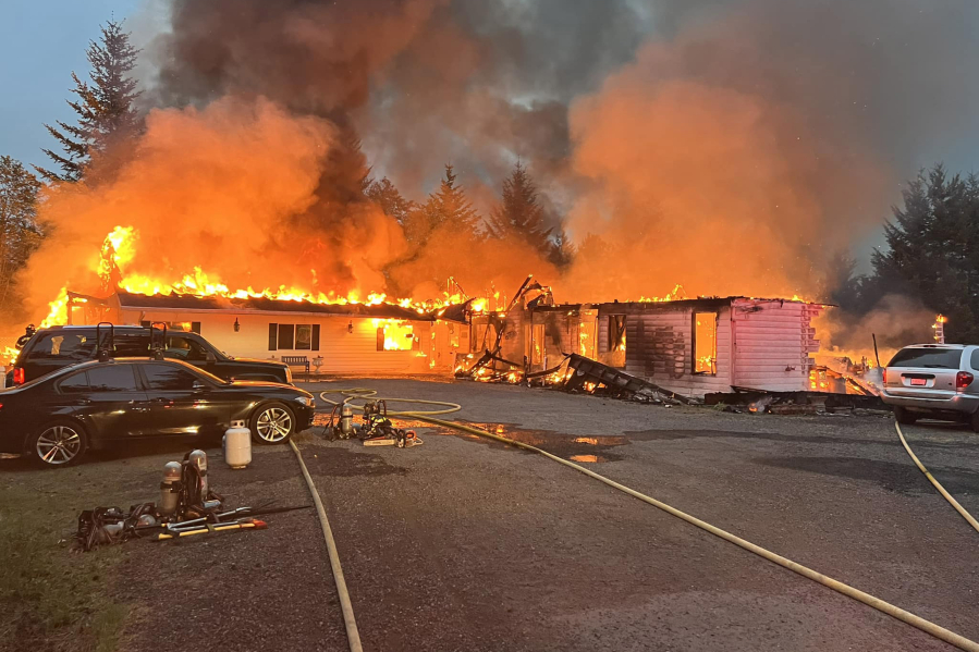 An adult family living center burns Tuesday morning north of Camas. Ten residents were displaced and the building was destroyed.