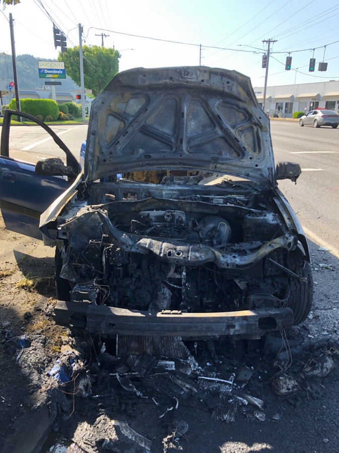 A Kia Rio after it crashed into an SUV Thursday afternoon on the St. John's Bridge in Portland and caught fire. Police say a Vancouver man was under the influence of alcohol when he drove the car for miles while it was on fire.