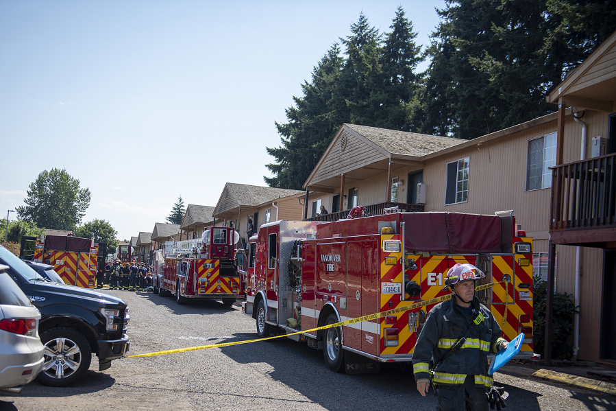 Pete Adams of the Vancouver Fire Department works at the scene July 28, 2022, as firefighters respond to a two-alarm fire at the Birchwood Lane Apartments. The blaze was contained to one downstairs unit, and no injuries were reported.