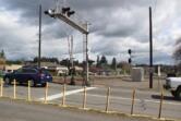 Traffic proceeds north on 32nd Street across a set of railroad tracks in Washougal.