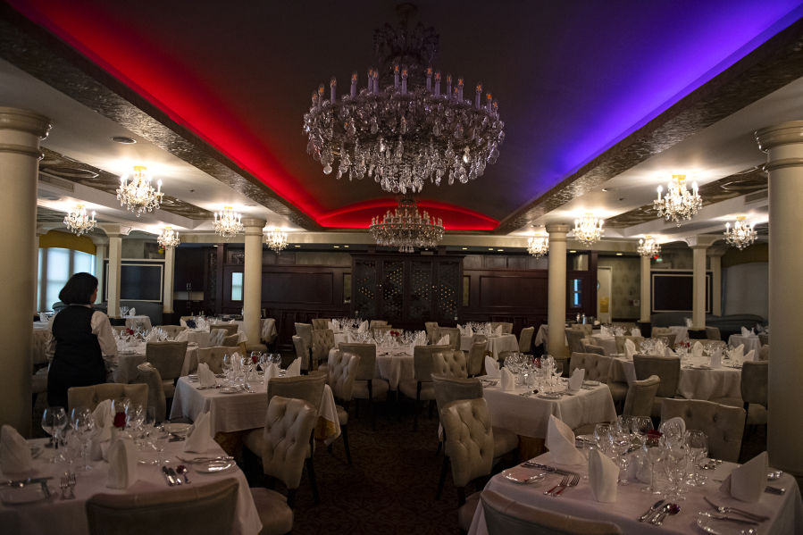 Chandeliers hang from the ceiling aboard the American Empress in the formal dining area.