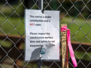 A note informs visitors not to trespass as a fence blocks access to the new disc golf course at Hockinson Meadows Community Park, which is still under construction.