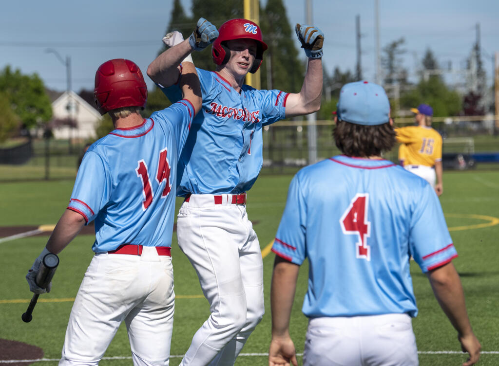 Mark Morris senior Langston Bartell, center, celebrates with teammates after hitting a home run Friday, May 12, 2023, during the Monarchs’ 8-4 win against Columbia River in a 2A district baseball playoff game at the Ridgefield Outdoor Recreation Complex.