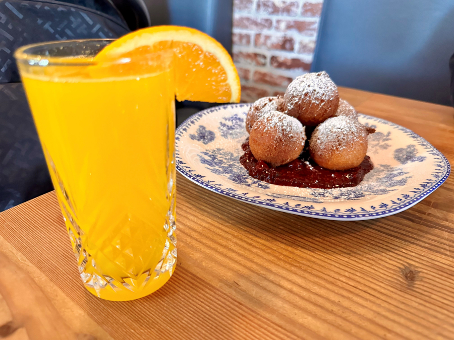 Fresh-squeezed orange juice, left, sits next to abuelita's doughnuts resting in a pool of berry compote at Cecilia in Vancouver.