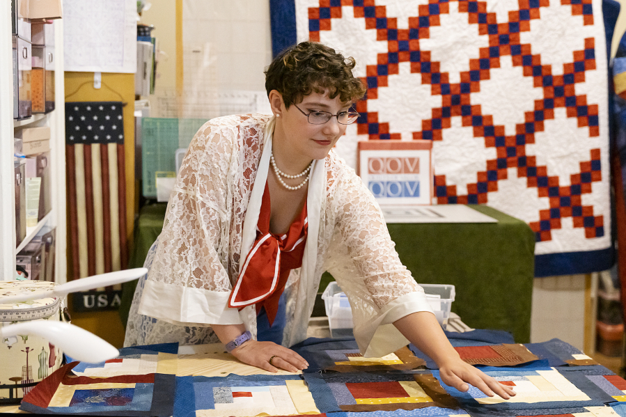 Morgane Starke, 23, helps to make a quilt for her father, a U.S. Marine Corps veteran, at a recent Quilts of Valor session. This is Starke's first experience with a quilting circle.