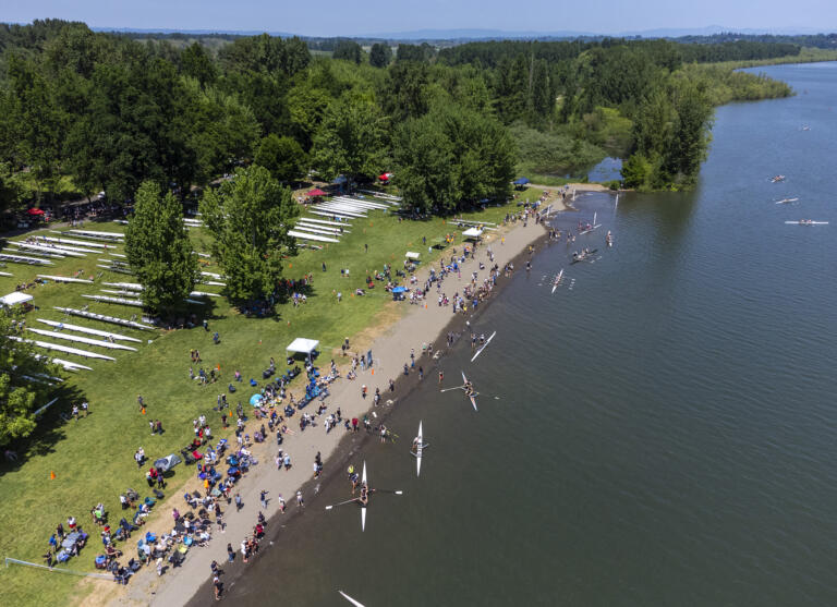 Spectators line the beach of Vancouver Lake while rowers wait just offshore on Friday, May 19, 2023, during the U.S. Rowing Northwest Youth Championship Regatta at Vancouver Lake Park. The three-day event is expected to draw between 1,500 and 3,000 rowers over the course of the competition.