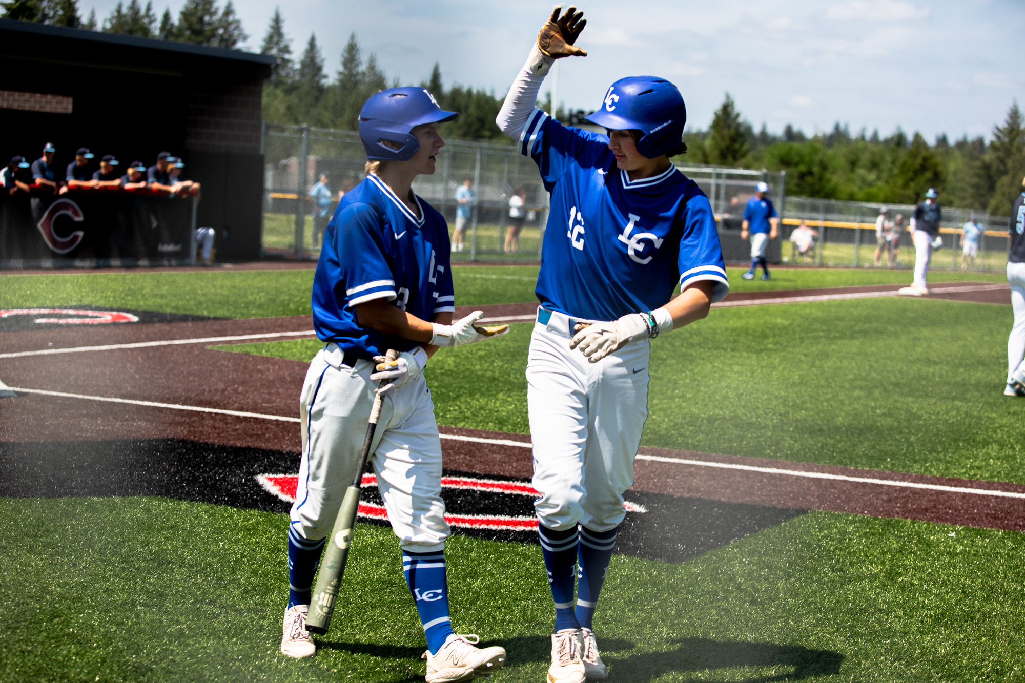 Garrett Maunu and Caden Taylor of LaCenter congratulate each other during the first round of the 1A state playoffs vs Lynden Christian on May 20th, 2023 at Camas High School.