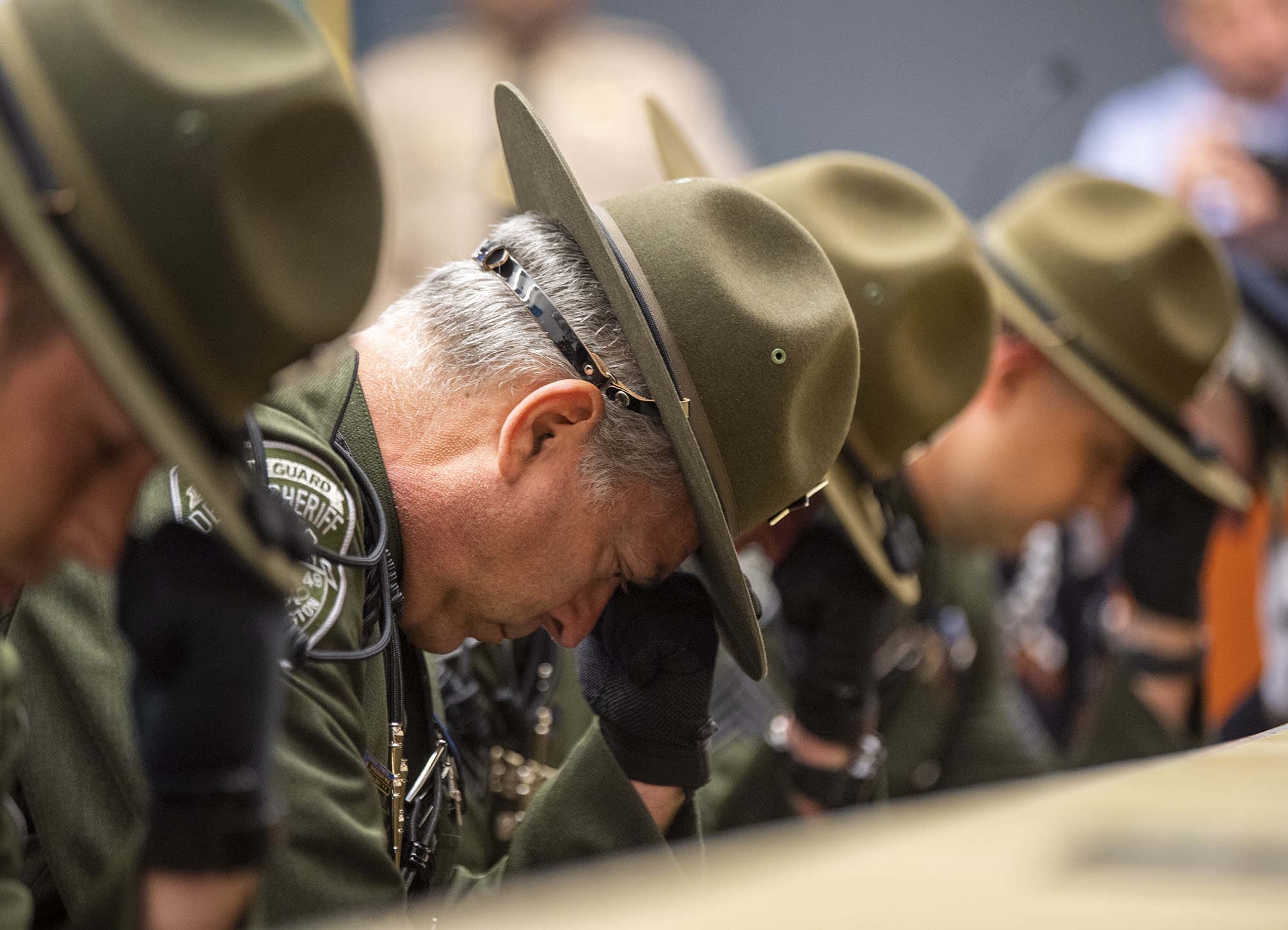 Honor Guard members kneel during the bell ringing ceremony Thursday, May 18, 2023, during the Clark County Law Enforcement Memorial Ceremony at the Vancouver Public Service Center.