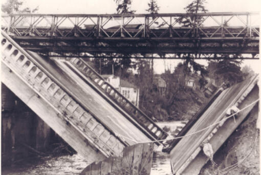 In early January 1956, heavy rains and melting snow supersaturated Clark County soil, creating landslides, washing out county roads, producing power outages and undermining the foundation of the Salmon Creek Bridge, causing it to collapse into a V-shape. The bridge failure halted Highway 99 travel in both directions until a temporary Bailey bridge from Fort Lewis restored traffic days later.