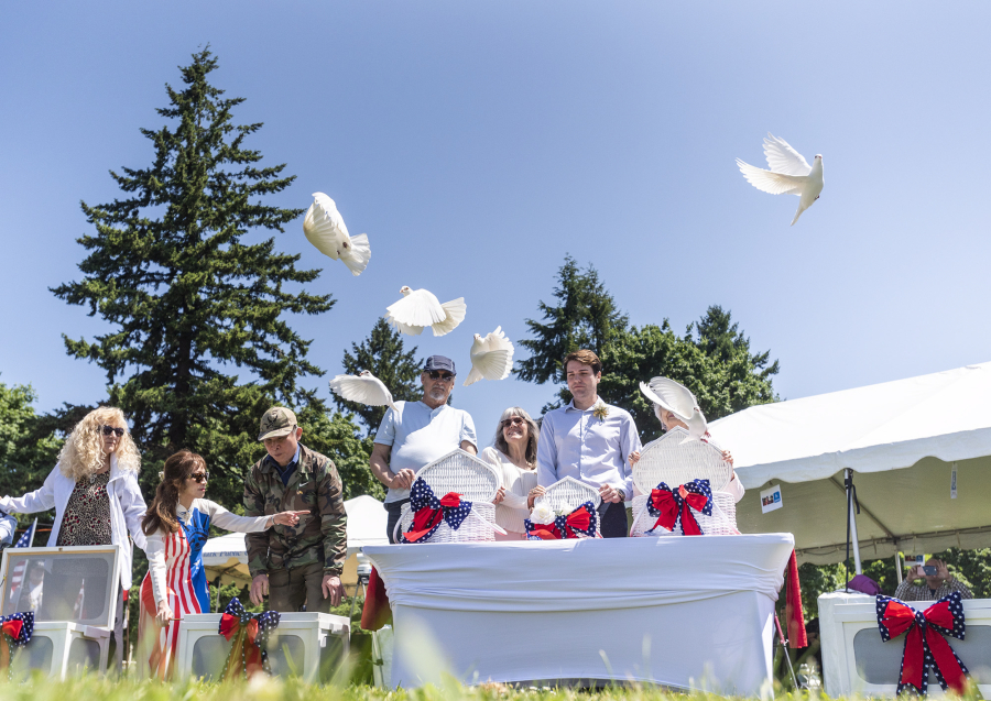 Dignitaries release white doves Monday during a Memorial Day ceremony at Fort Vancouver National Historic Site.
