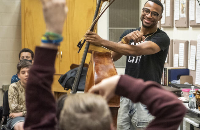 World class double bassist Xavier Foley, right, answers questions from fascinated Jason Lee Middle School students on Tuesday at the school.