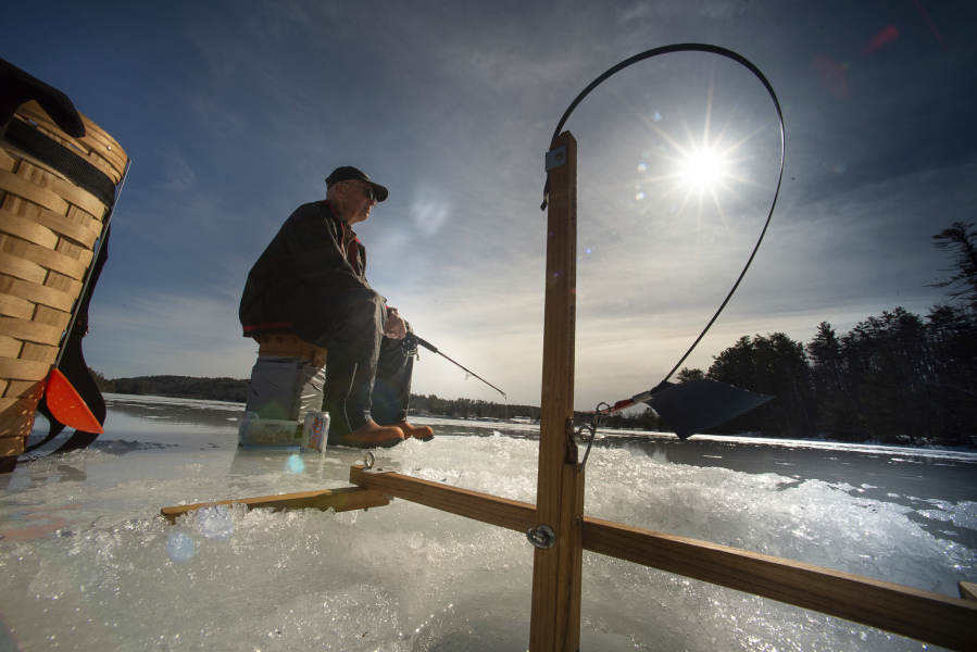 Wayne York jigs as he watches for flags on Pennesseewassee Lake on Feb. 16 in Norway, Maine. Maine was the oldest state in the U.S., with a median age of 45.1, a result of a decline in working-age adults as baby boomers aged.