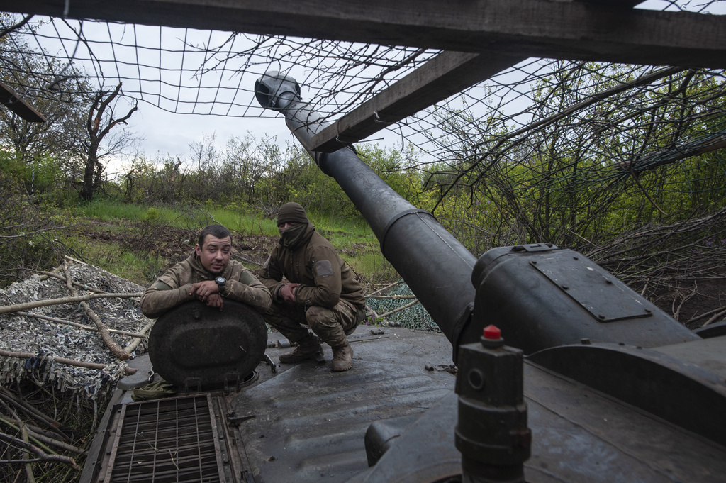 Ukrainian soldiers look out a self-propelled howitzer in Chasiv Yar, the site of heavy battles with the Russian forces in the Donetsk region, Ukraine, Thursday, May 11, 2023.