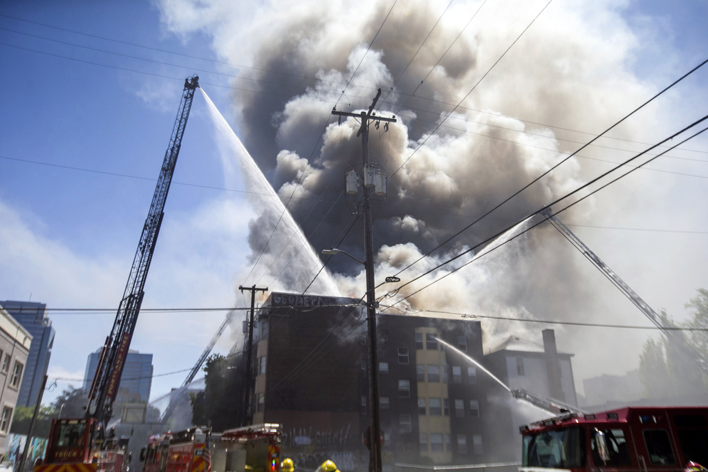 Portland Fire &amp; Rescue work at the scene of a major apartment fire in downtown Portland, Ore., Tuesday, May 16, 2023. Firefighters rescued people and at least one dog from a dramatic, three-alarm apartment fire in downtown Portland on Tuesday before they were ordered to fall back.