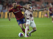 Real Salt Lake forward Danny Musovski (17) and Portland Timbers defender Claudio Bravo, right, compete for the ball during the second half of an MLS soccer match Wednesday, May 17, 2023, in Sandy, Utah.
