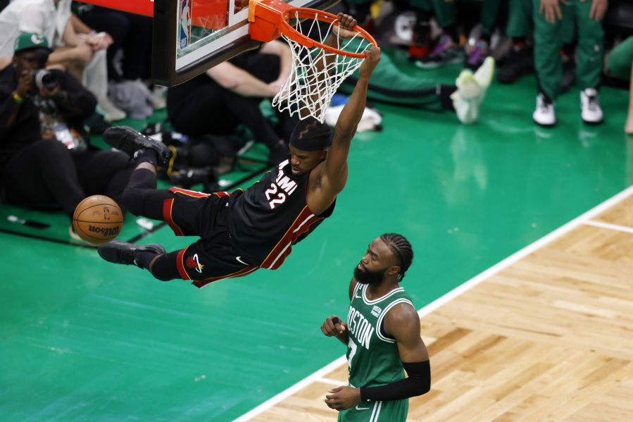 Miami Heat forward Jimmy Butler, left, dunks as Boston Celtics guard Jaylen Brown defends during the second half in Game 7 of the NBA basketball Eastern Conference finals Monday, May 29, 2023, in Boston.