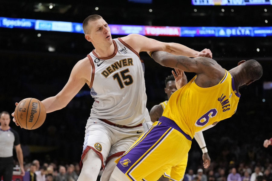 Denver Nuggets center Nikola Jokic (15) collides with Los Angeles Lakers forward LeBron James (6) in the second half of Game 4 of the NBA basketball Western Conference Final series Monday, May 22, 2023, in Los Angeles.