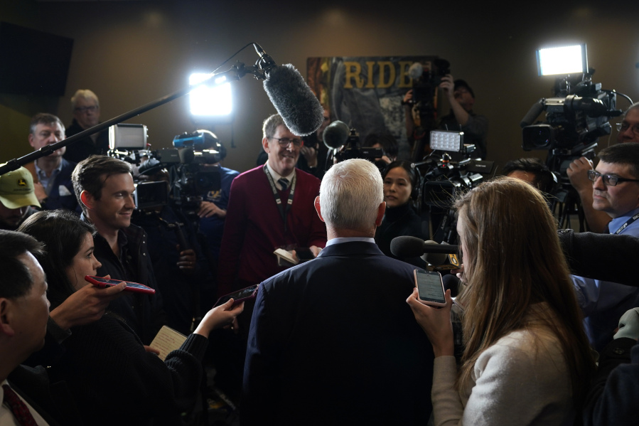 FILE - Former Vice President Mike Pence, center, talks to reporters after speaking at a parents rights rally on Feb. 15, 2023, in Cedar Rapids, Iowa. Nearly three-quarters of U.S. adults say the news media is increasing political polarization in this country, and just under half say they have little to no trust in the media's ability to report the news fairly and accurately, according to a new survey from The Associated Press-NORC Center for Public Affairs Research and Robert F. Kennedy Human Rights.