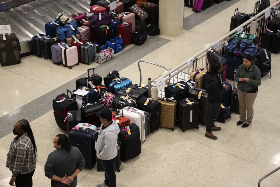 FILE - Hundreds of Southwest Airlines checked bags are piled together at baggage claim at Midway International Airport as Southwest continues to cancel thousands of flights across the country on Dec. 28, 2022, in Chicago. The Biden administration is working on new regulations that would require airlines to compensate passengers and cover their meals and hotel rooms if they are stranded for reasons within the airline's control. The White House said President Joe Biden and Transportation Secretary Pete Buttigieg would announce the start of the rulemaking process Monday May 8, 2023.