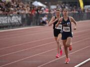 Seton Catholic junior Alexis Leone, right, leads Port Townsend's Aliyah Yearian during the 1,600 meters at the Class 1A state track and field championships on Thursday, May 25, 2023 at Zaepfel Stadium in Yakima. Leone won in 4 minutes, 59.30 seconds to repeat as state champion.
