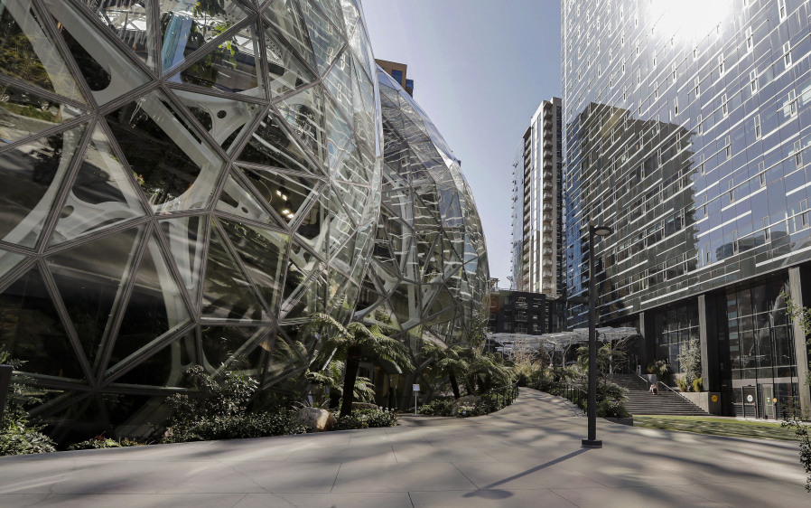 FILE - The exterior of the Amazon headquarters is shown in Seattle Friday, March 20, 2020. A group of Amazon workers upset about recent layoffs, a return-to-office mandate and the company's environmental impact is planning a walkout at its Seattle headquarters Wednesday.