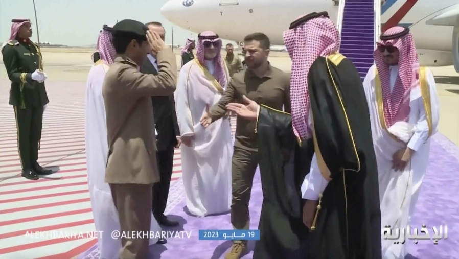 This video grab shows Ukrainian President Volodymyr Zelenskyy, center, arriving at the airport in Jeddah, Saudi Arabia, Friday May 19, 2023.