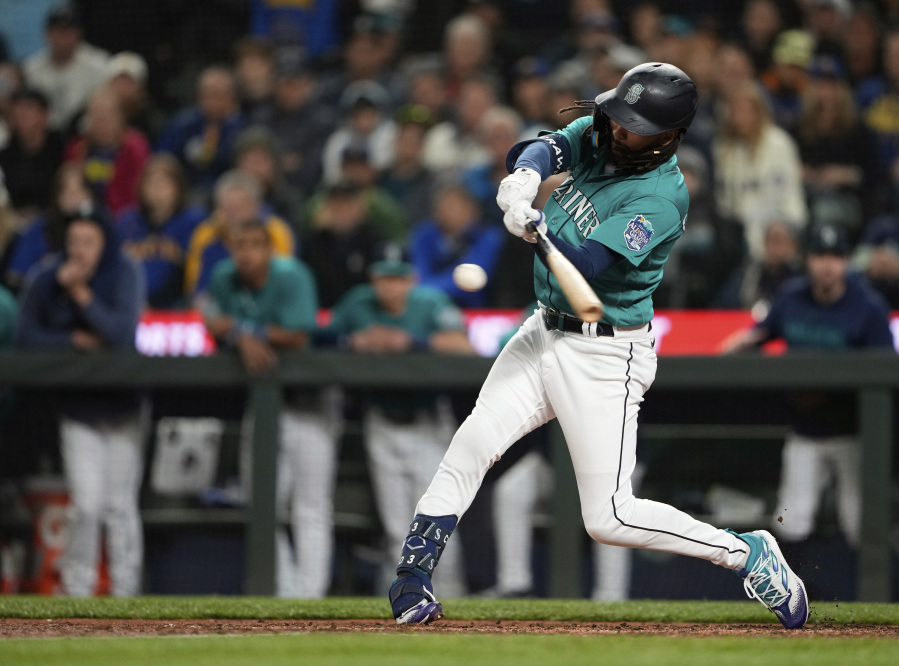 Seattle Mariners' J.P. Crawford hits a three-run double against the Houston Astros during the eighth inning of a baseball game Saturday, May 6, 2023, in Seattle.