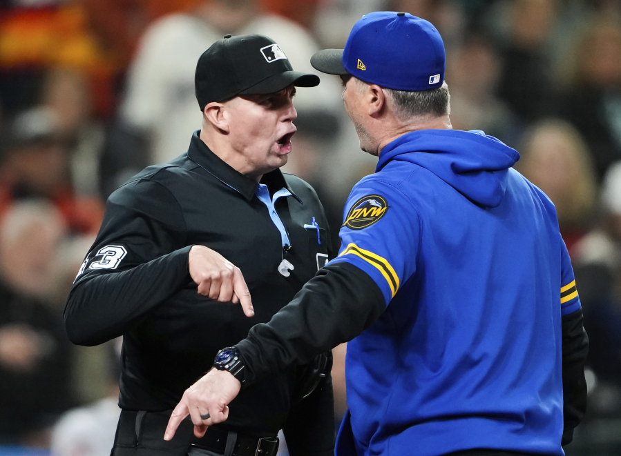 Home plate umpire Shane Livensparger argues with Seattle Mariners manager Scott Servais during the ninth inning of a baseball game against the Houston Astros, Friday, May 5, 2023, in Seattle. Servais was ejected.