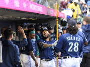 Seattle Mariners' J.P. Crawford (3) holds a trident after his two-run home run against the Oakland Athletics during the fifth inning of a baseball game Tuesday, May 23, 2023, in Seattle.