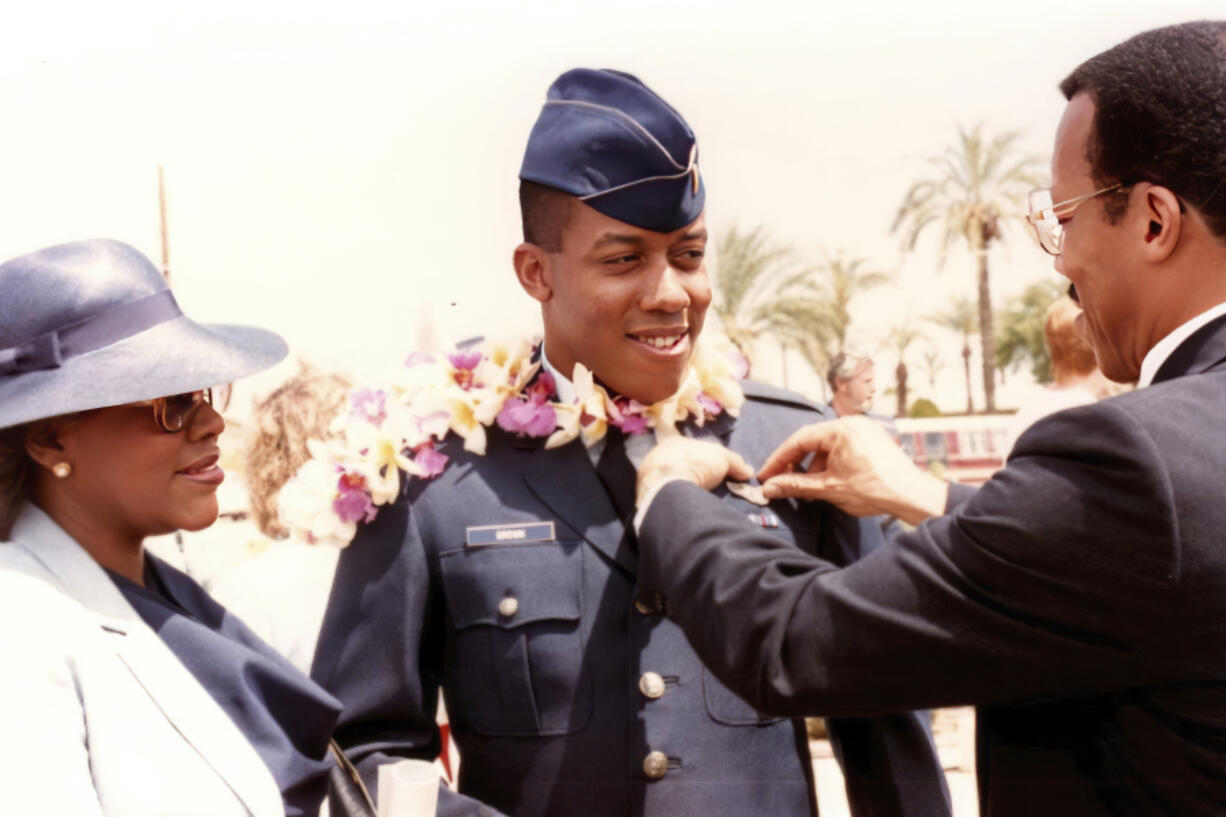 In this photo provided by the Brown family, retired Army Col. Charles Q. Brown, Sr., father, and his wife Kay Brown, pin Air Force wings onto the uniform of their son, 2nd Lt. CQ Brown, Jr., at his pilot training graduation at Williams Air Force Base, Ariz., in 1986.
